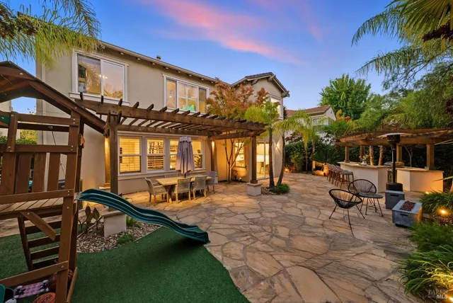 a view of a patio with a table and chairs