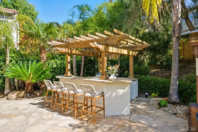a view of a house with a yard and potted plants