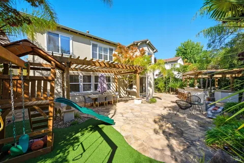 a spacious bathroom with a double vanity sink a mirror and a toilet