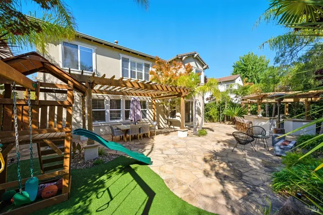 a spacious bathroom with a double vanity sink a mirror and a toilet