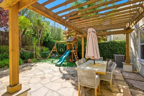 a living room with furniture and a book shelf