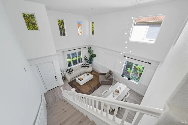 a front view of a house with a garden and trees