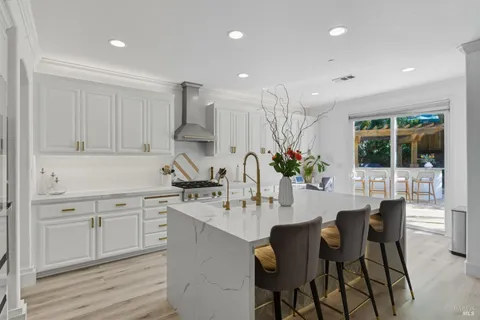 a kitchen with stainless steel appliances a white stove top oven and a white cabinets