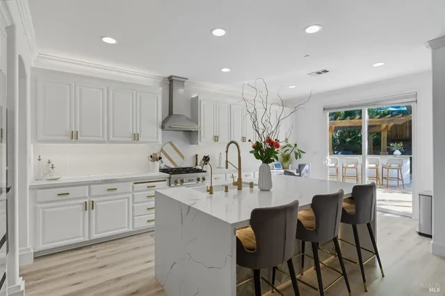 a kitchen with stainless steel appliances a white stove top oven and a white cabinets