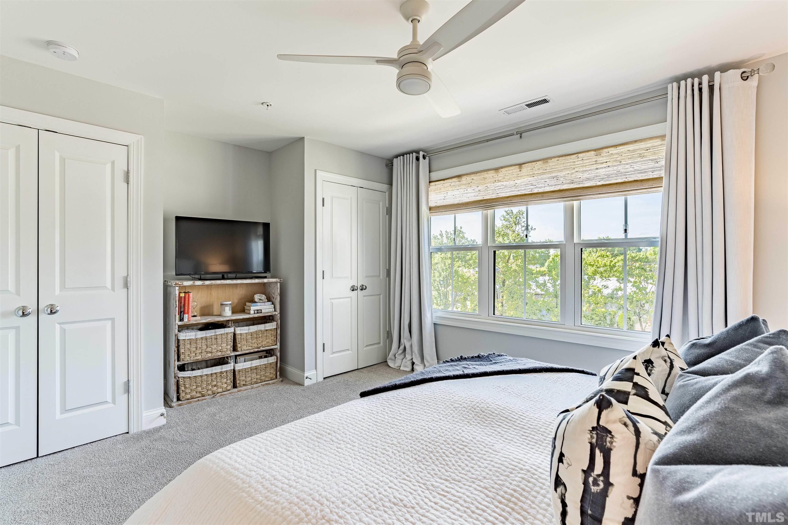6801 Milligan Way, Unit 107 Raleigh, NC 27613 - Photo 14 of 27 a spacious bedroom with a bed and a large window