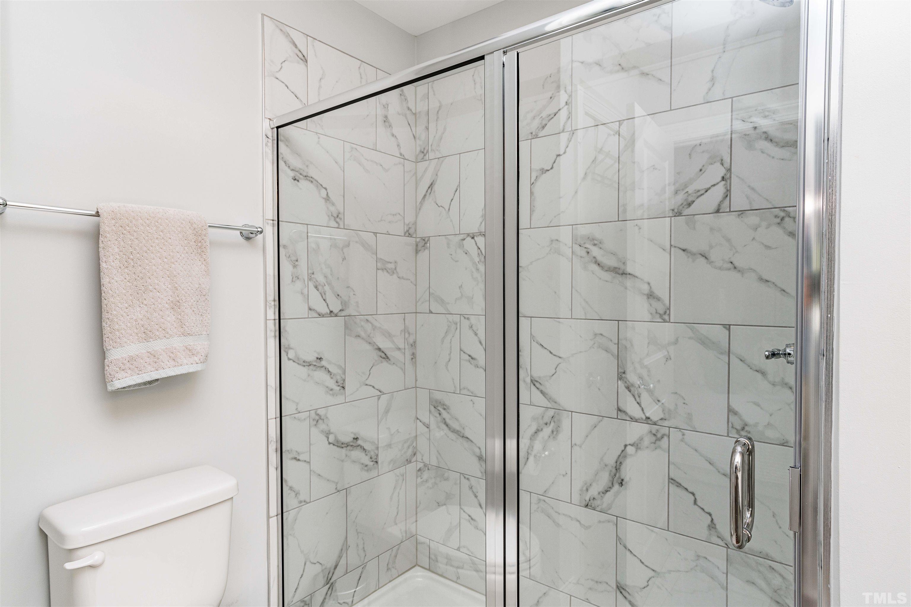 6801 Milligan Way, Unit 107 Raleigh, NC 27613 - Photo 16 of 27 a bathroom with a shower and a toilet