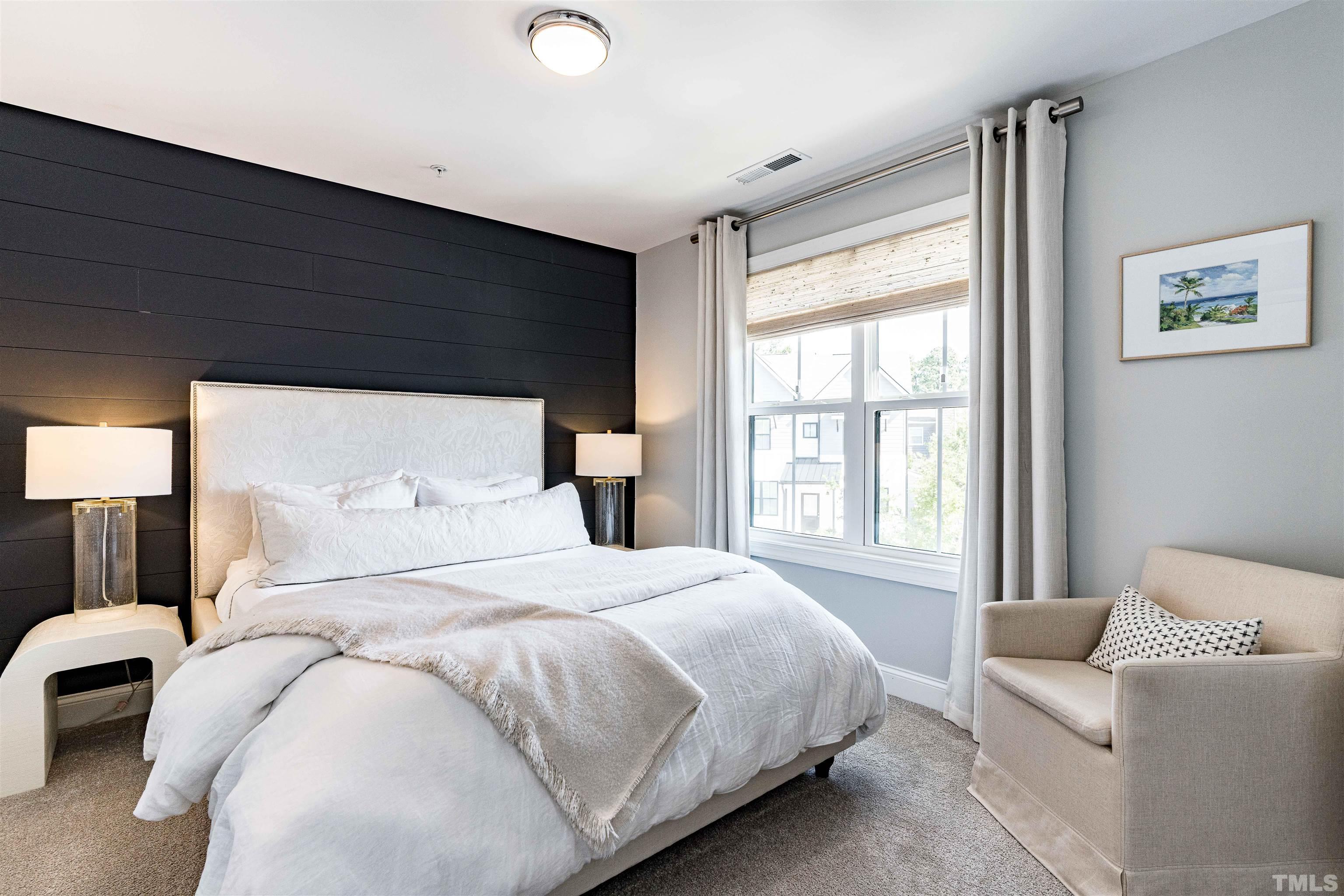 6801 Milligan Way, Unit 107 Raleigh, NC 27613 - Photo 17 of 27 a bedroom with a bed and a large window