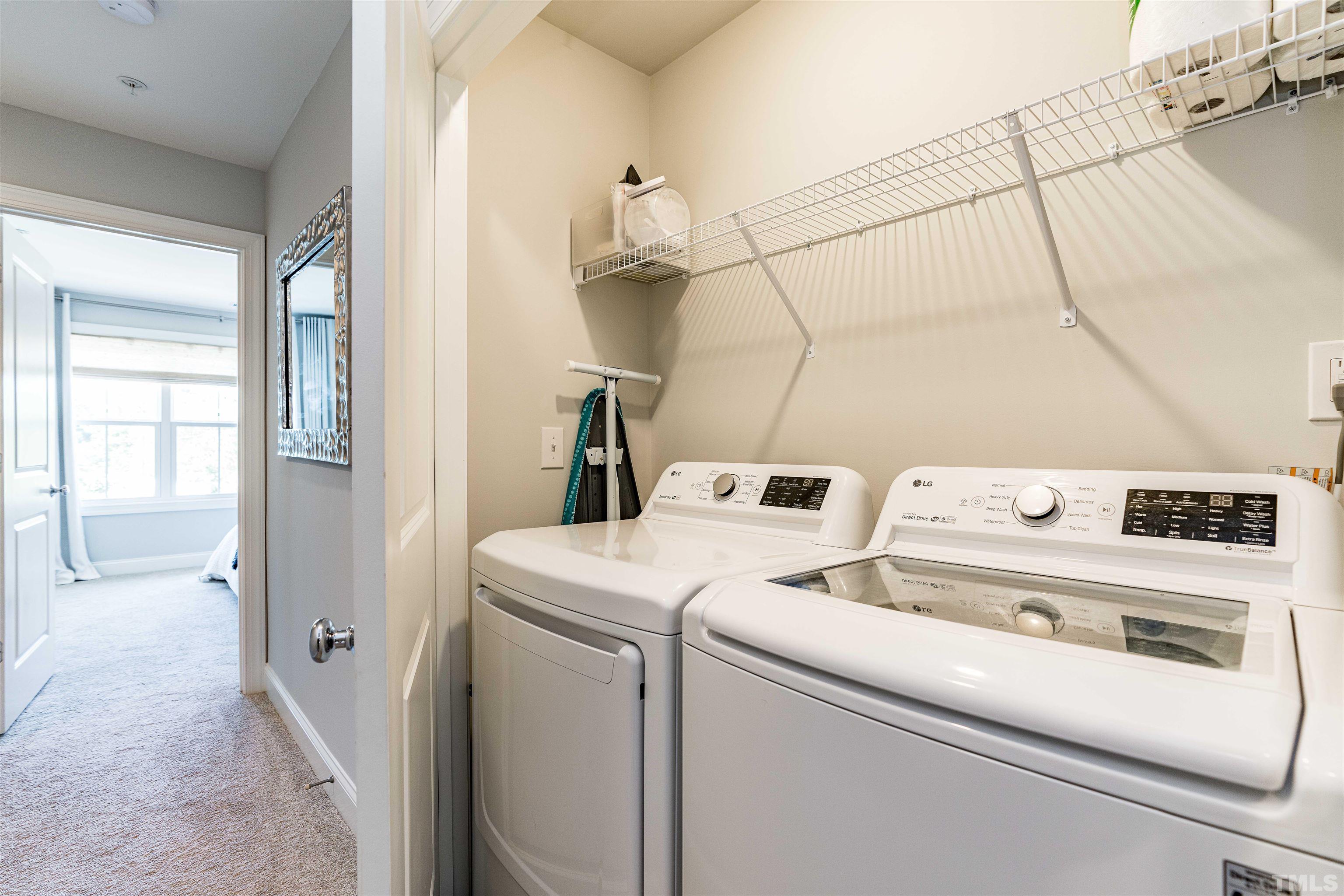 6801 Milligan Way, Unit 107 Raleigh, NC 27613 - Photo 20 of 27 a view of washer and dryer with bathroom in the background