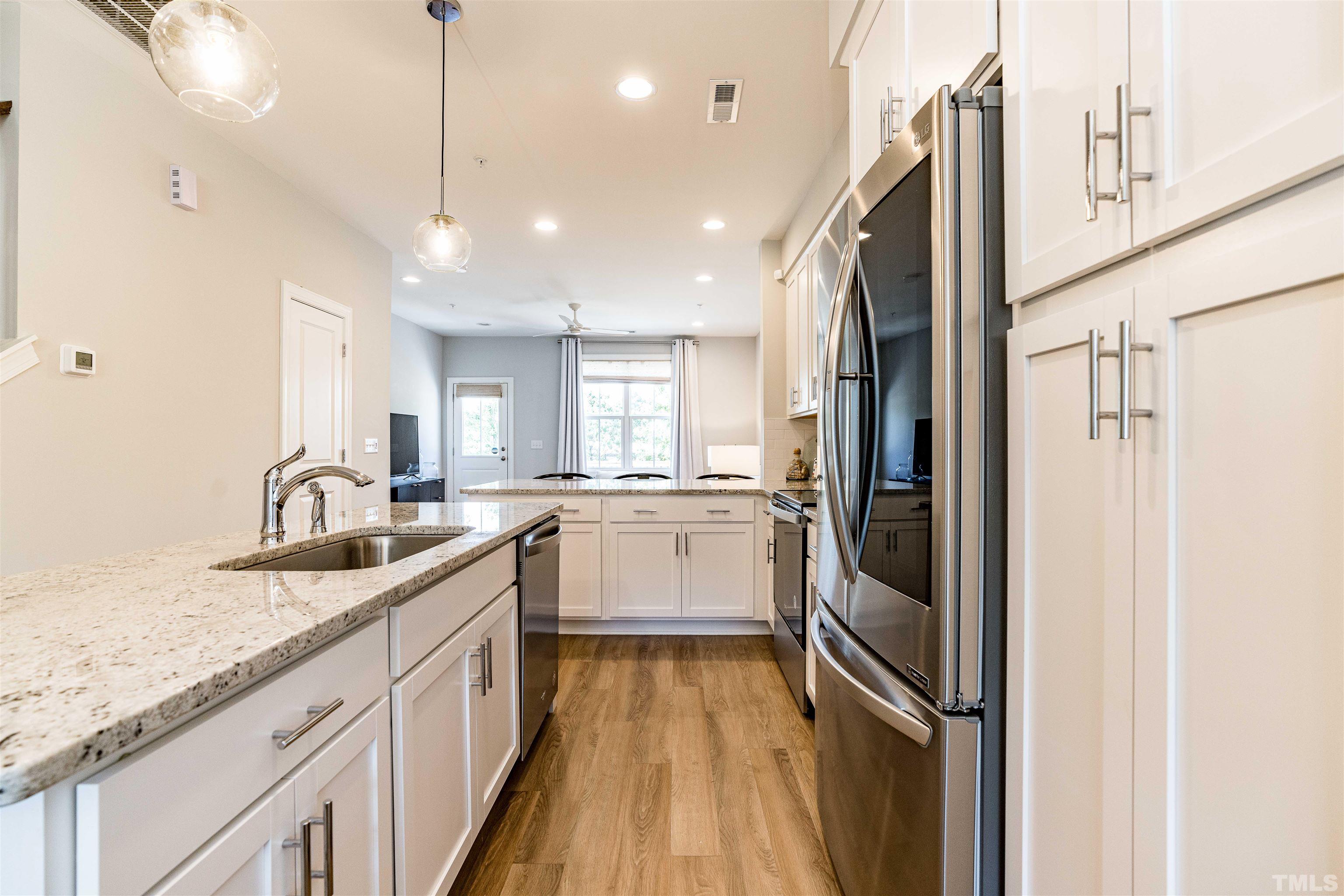 6801 Milligan Way, Unit 107 Raleigh, NC 27613 - Photo 4 of 27 a view of a kitchen with a sink and dishwasher