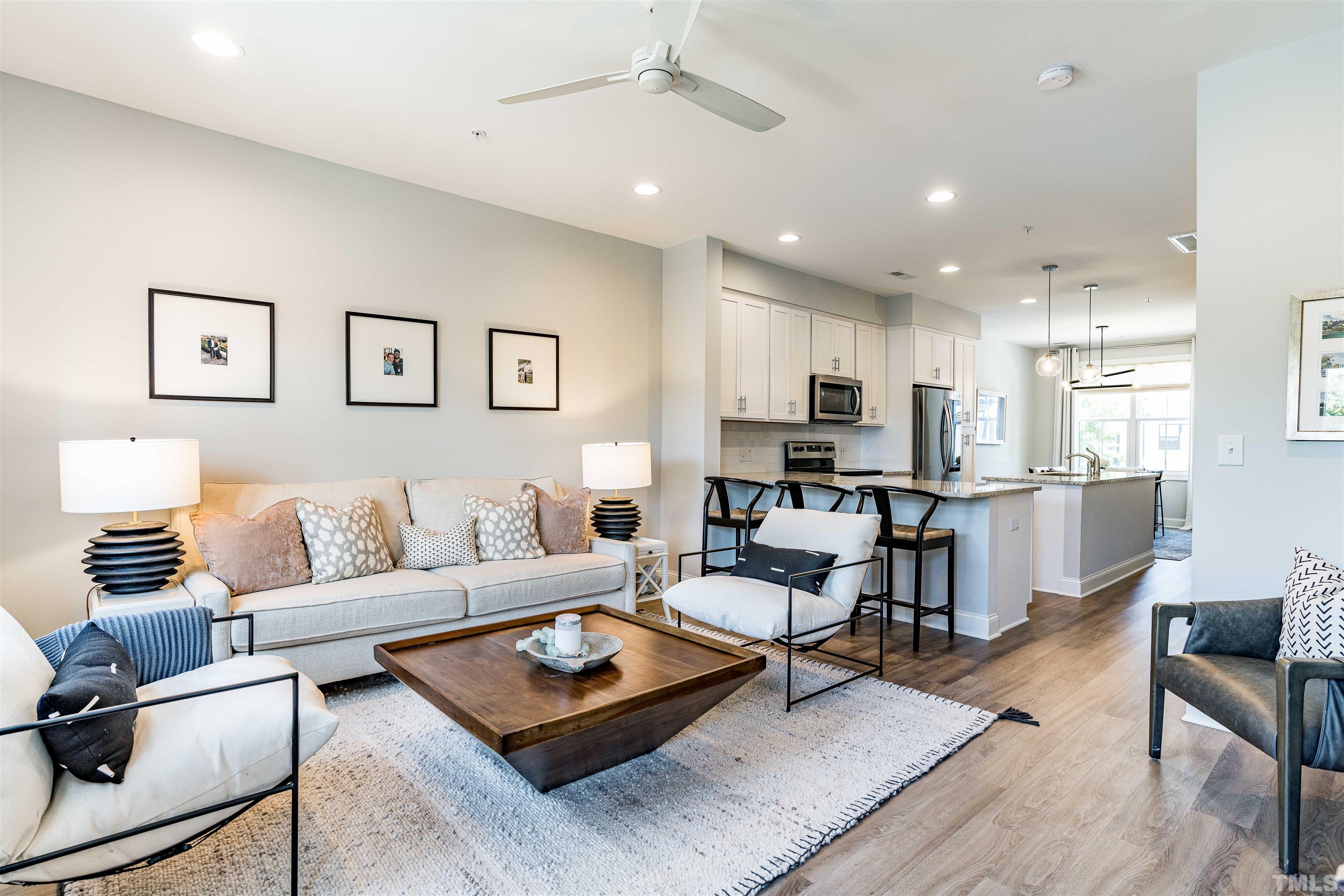 6801 Milligan Way, Unit 107 Raleigh, NC 27613 - Photo 9 of 27 a living room with furniture kitchen view and a table
