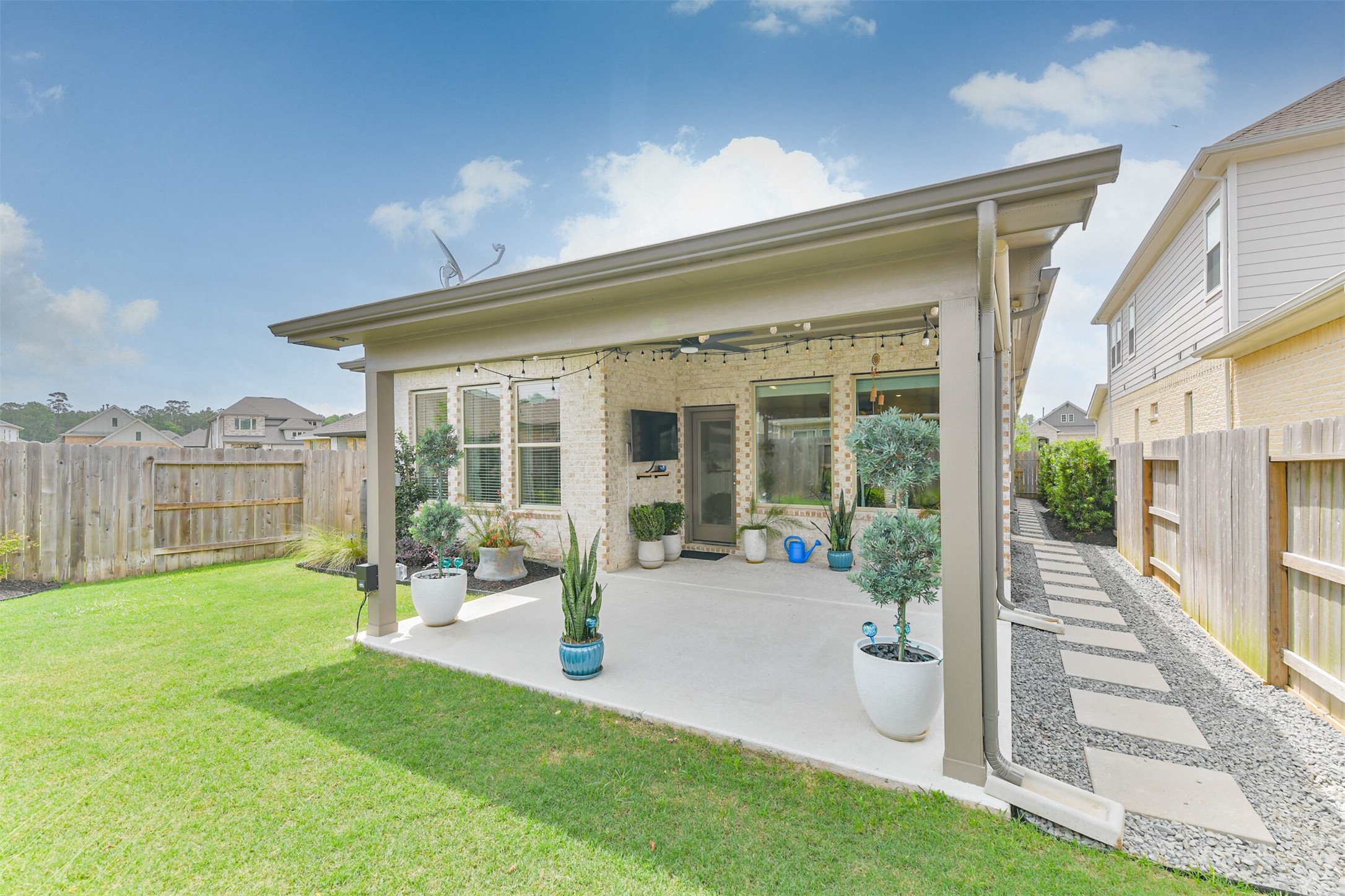 15611 Rising Wren Court Conroe, TX 77302 - Photo 22 of 38 a front view of a house with a yard table and chairs