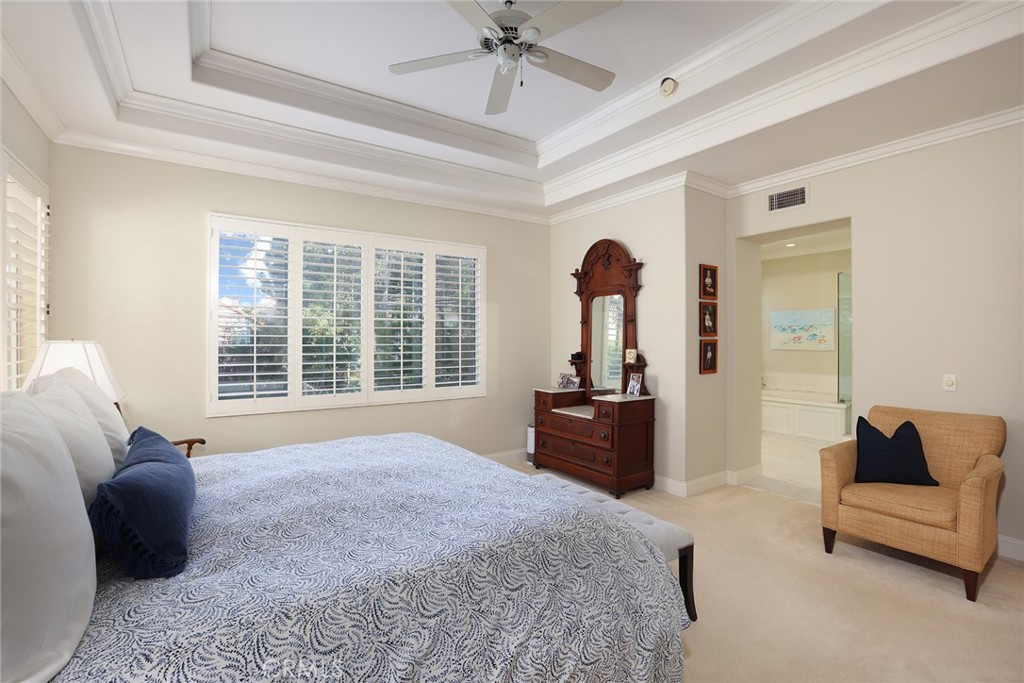 9 Chaminade Newport Coast, CA 92657 - Photo 15 of 29 a bedroom with a bed and a chandelier