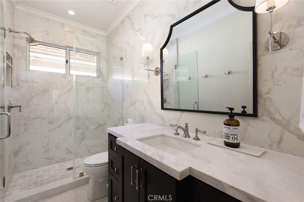 9 Chaminade Newport Coast, CA 92657 - Photo 19 of 29 a bathroom with a shower sink vanity mirror and toilet