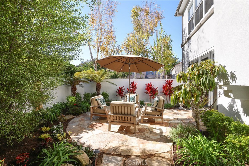 9 Chaminade Newport Coast, CA 92657 - Photo 20 of 29 a patio with a table and chairs under an umbrella
