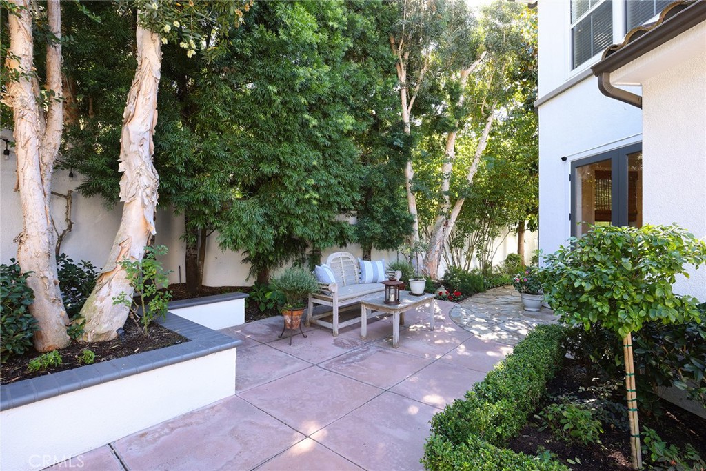 9 Chaminade Newport Coast, CA 92657 - Photo 23 of 29 a view of a patio with table and chairs potted plants and large tree