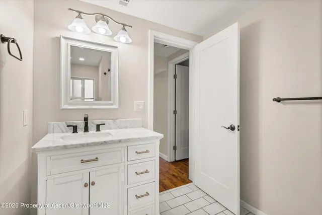 a bathroom with a sink vanity and a mirror