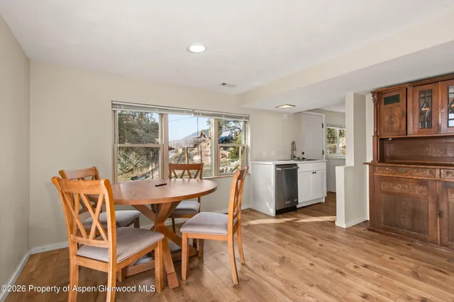 a view of a dining room with furniture and wooden floor