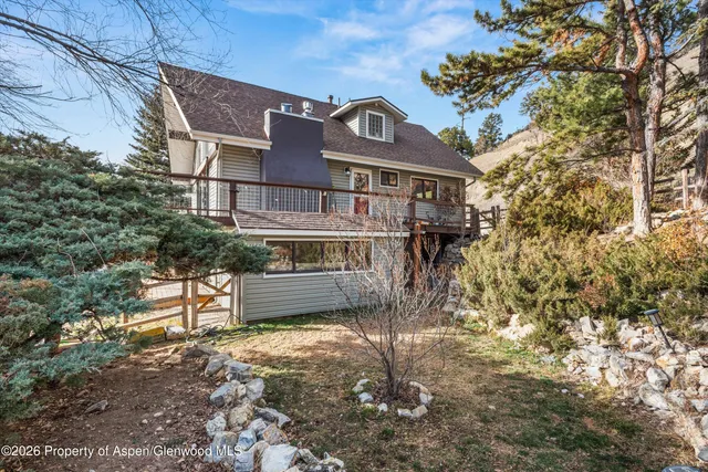 a view of a brick house with a yard