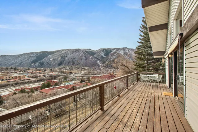 a view of balcony with wooden floor and fence