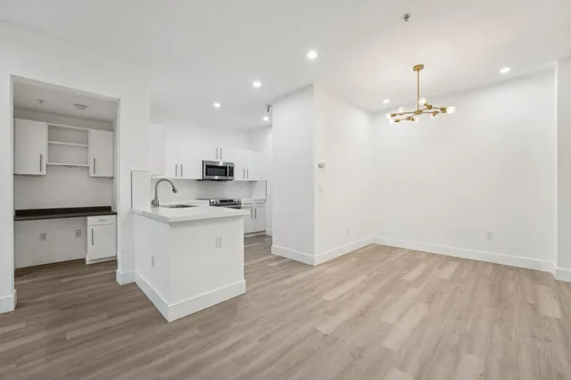 a kitchen with a white cabinets stove and refrigerator