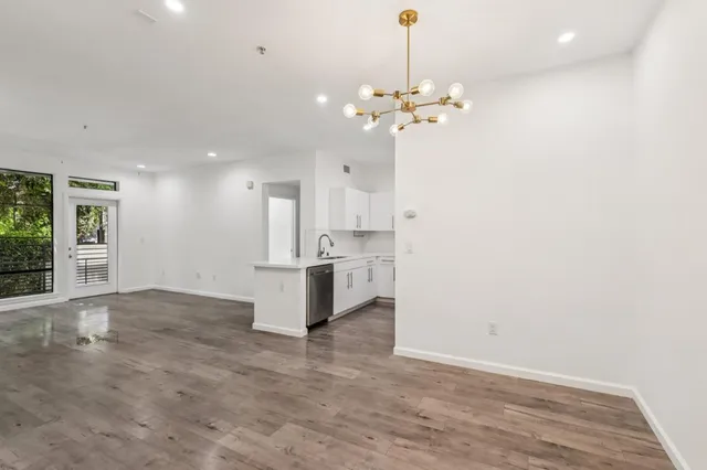 a view of a kitchen with a sink and chandelier