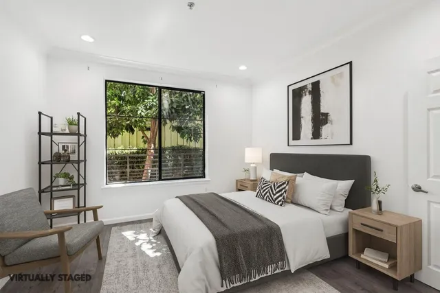 a bedroom with a large bed and a window