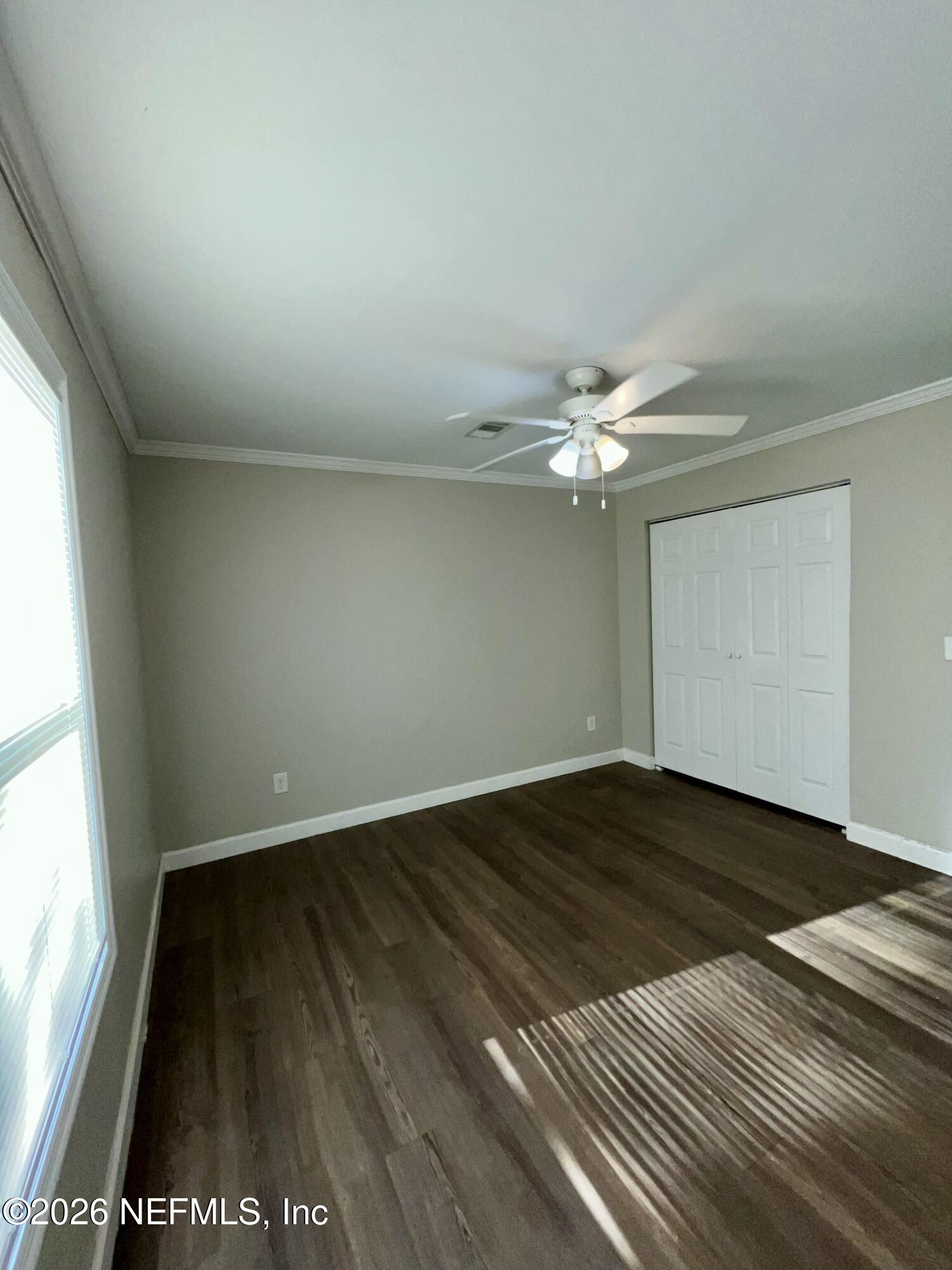 2017 Talladega Road Jacksonville, FL 32209 - Photo 31 of 34 wooden floor in an empty room with a window