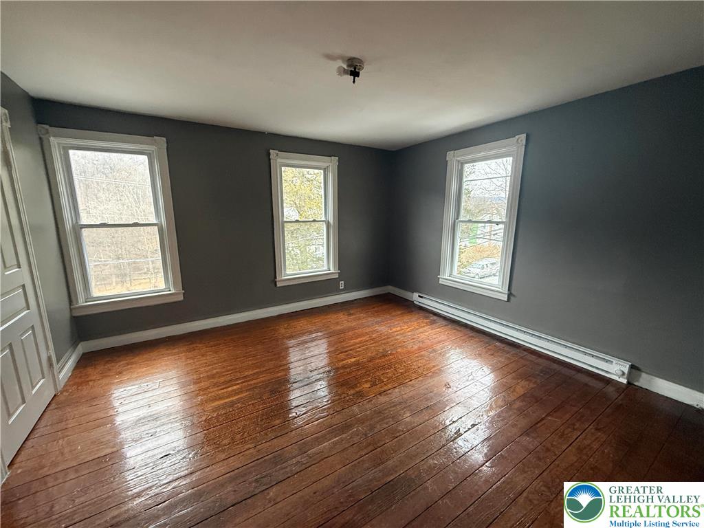 3714 Old Mill Road Slatington, PA 18080 - Photo 11 of 18 a view of an empty room with wooden floor and a window