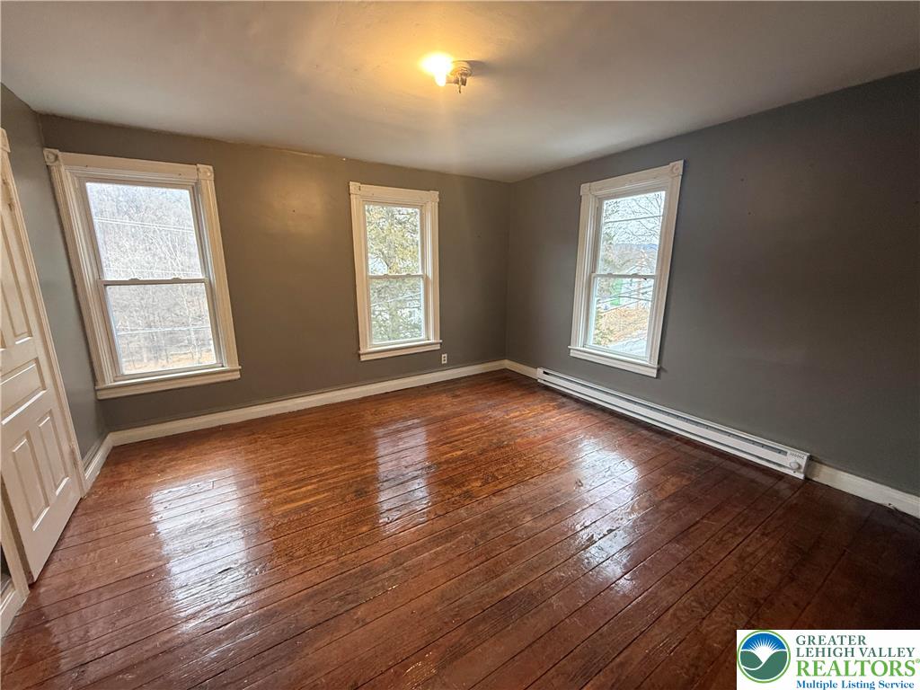 3714 Old Mill Road Slatington, PA 18080 - Photo 13 of 18 a view of an empty room with wooden floor and a window