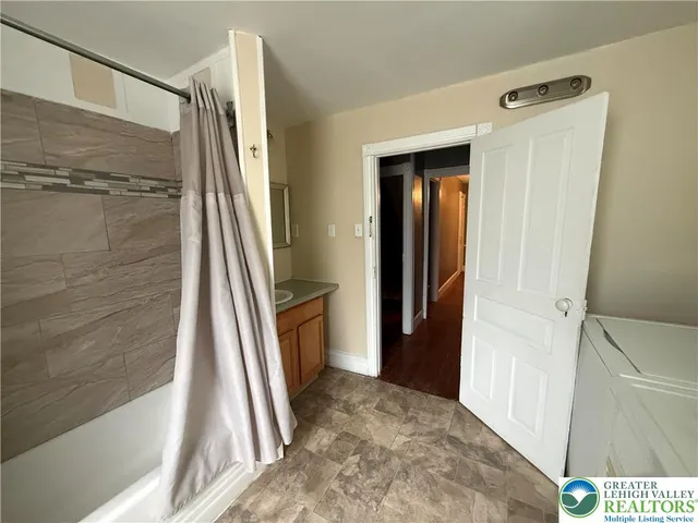 a view of a bathroom from a corridor