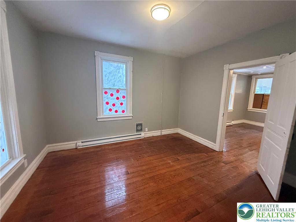 3714 Old Mill Road Slatington, PA 18080 - Photo 8 of 18 an empty room with wooden floor and windows