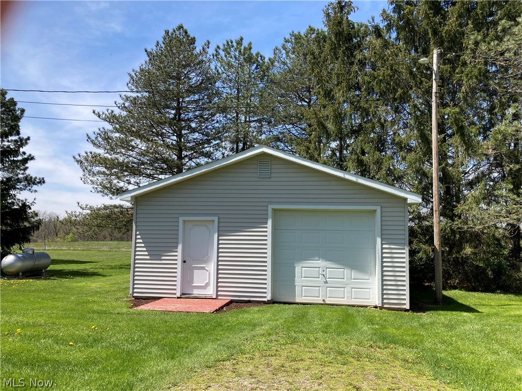 10370 Crow Road Litchfield, OH 44253 - Photo 23 of 39 The detached 2+ car garage (pole barn) features an electronic opener, work shop space, service door and natural lighting. As you can see, the home is heated with propane. Additionally, the living room fireplace and the basement wood-burning stove offer alternative heating options.