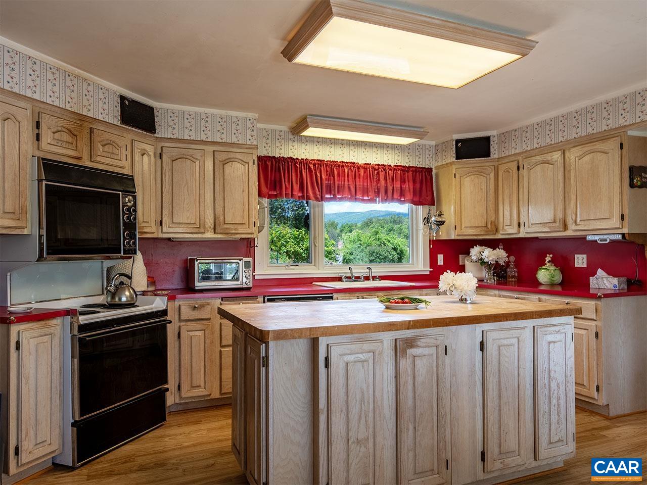7230 Plank Road Afton, VA 22920 - Photo 12 of 37 a kitchen with a stove a sink and a microwave