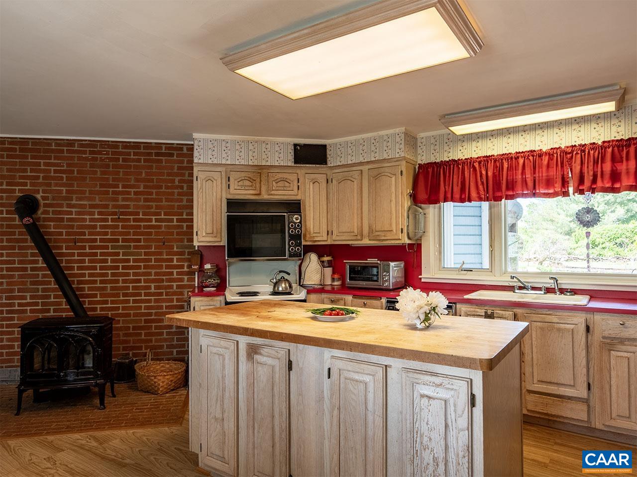 7230 Plank Road Afton, VA 22920 - Photo 13 of 37 a kitchen with stainless steel appliances a sink stove and cabinets