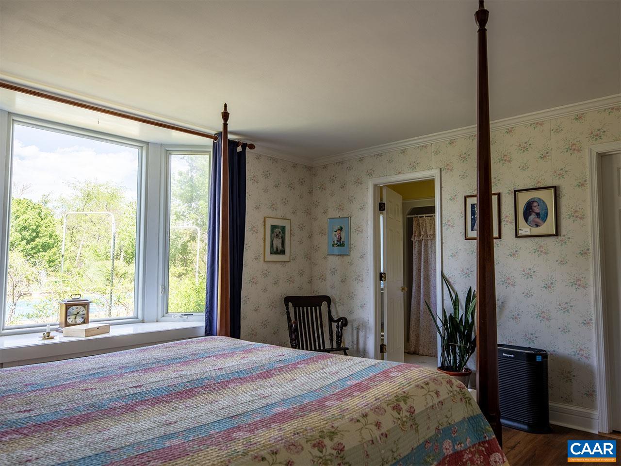 7230 Plank Road Afton, VA 22920 - Photo 17 of 37 a spacious bedroom with a large bed and a window