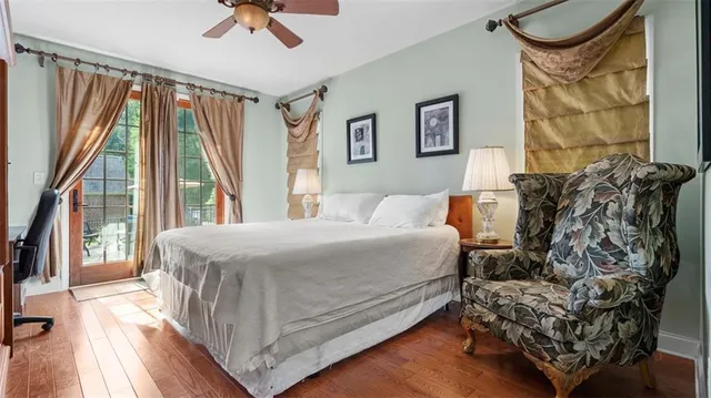 a bed sitting in a bedroom next to a window