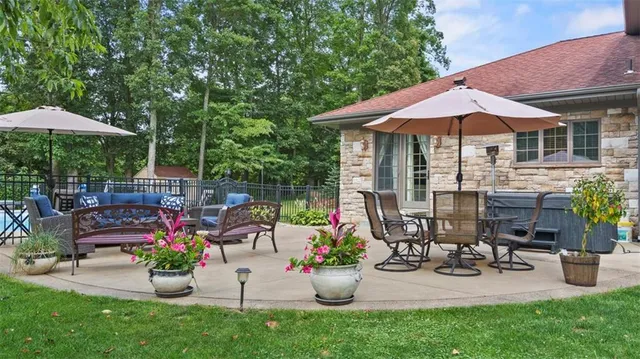 a view of a patio with table and chairs under an umbrella