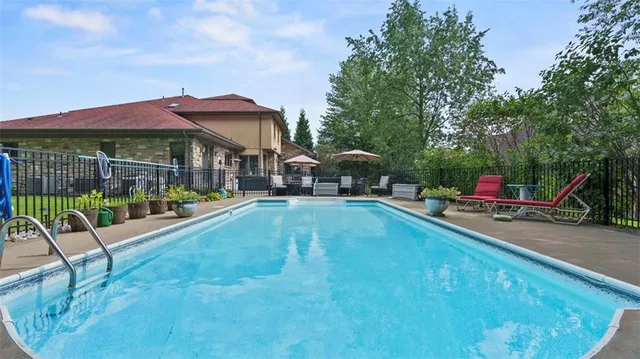 a swimming pool with outdoor seating yard and barbeque oven