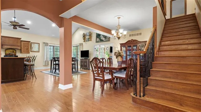 a view of a dining room with furniture and wooden floor