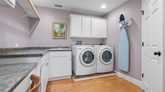 a utility room with sink dryer and washer