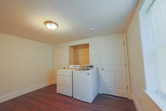 a view of a room with wooden floors and window