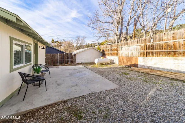 a living room with furniture and a chair
