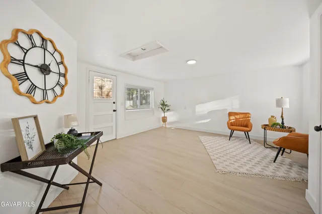 a view of a livingroom with furniture and a workspace