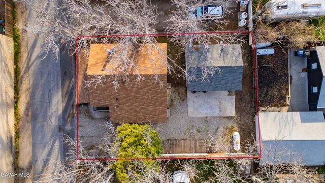 an aerial view of a house with a yard and garden