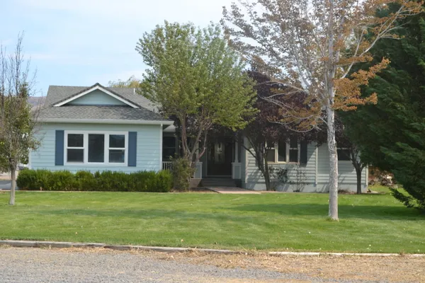 a living room with lots of furniture and a view of dining hall with wooden floor