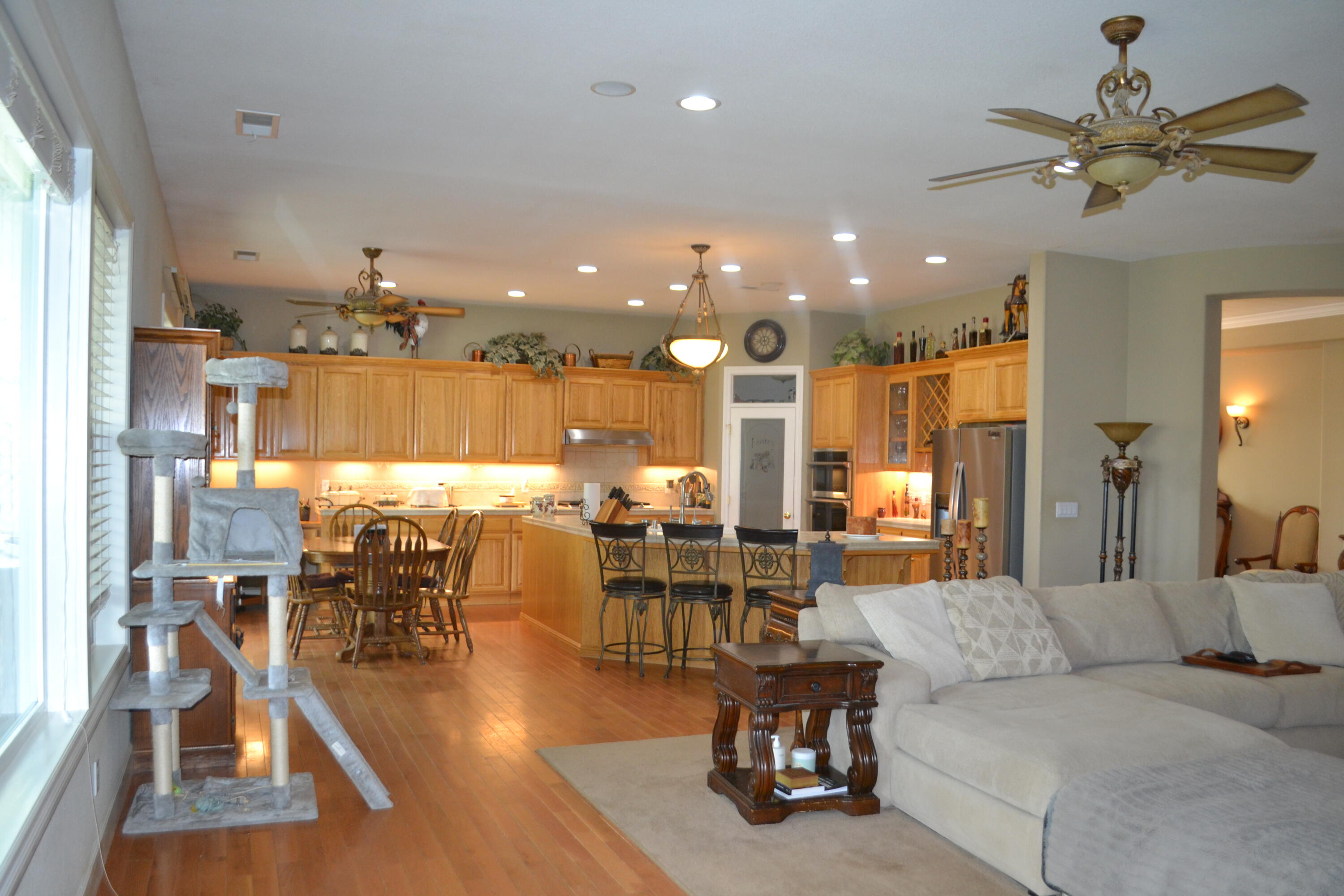 480-100 Belfast Road Litchfield, CA 96117 - Photo 22 of 100 a living room with lots of furniture and a view of dining hall with wooden floor