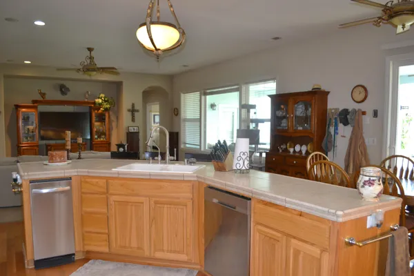 a living room with furniture a fireplace and a floor to ceiling window
