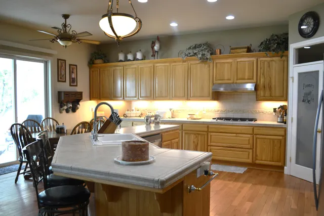 a living room with furniture a fireplace and a floor to ceiling window
