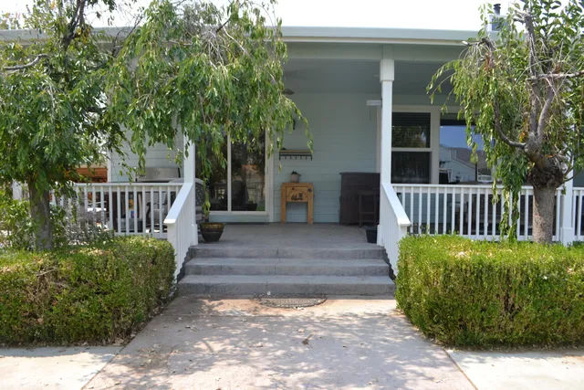a living room with a fireplace and a wooden floor