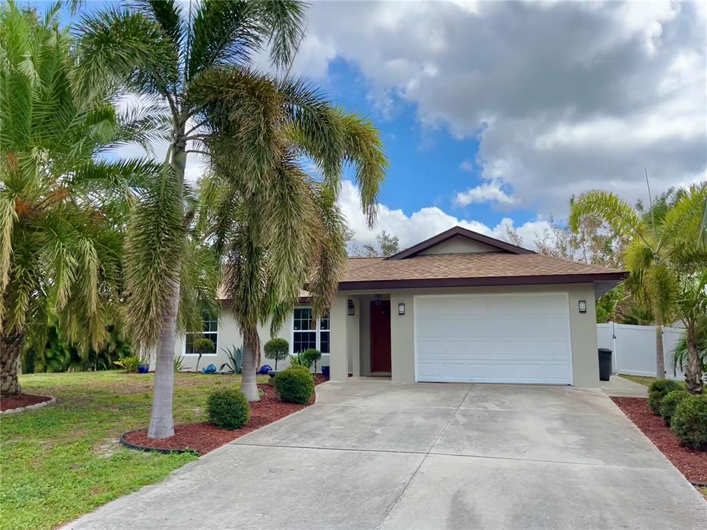 2607 Serpula Road Venice, FL 34293 - Photo 1 of 1 a front view of a house with a yard and garage